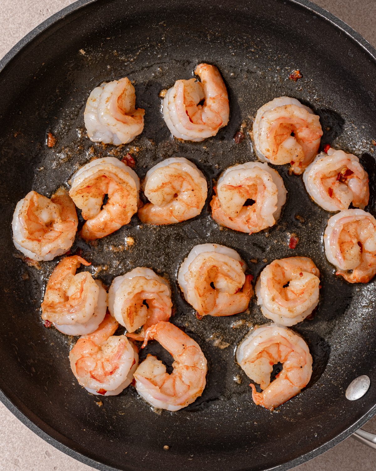 Cooked shrimp in a pan for spicy garlic shrimp recipe.