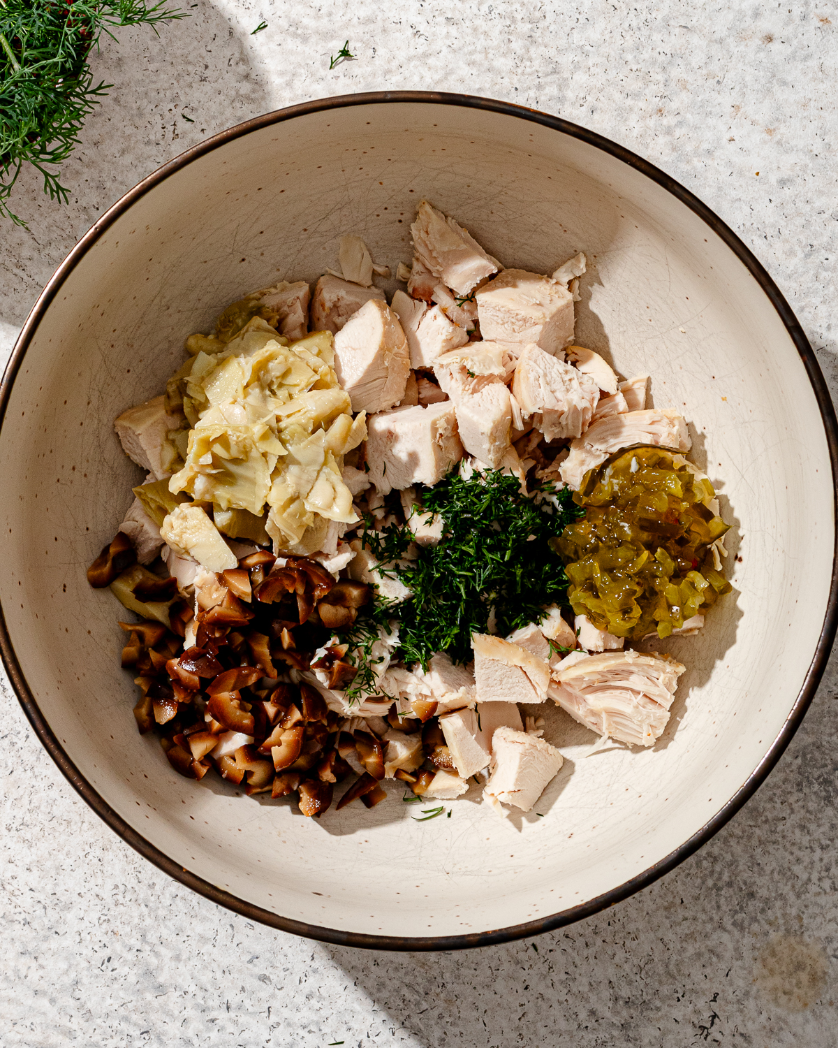 Ingredients for high protein chicken salad in a bowl.
