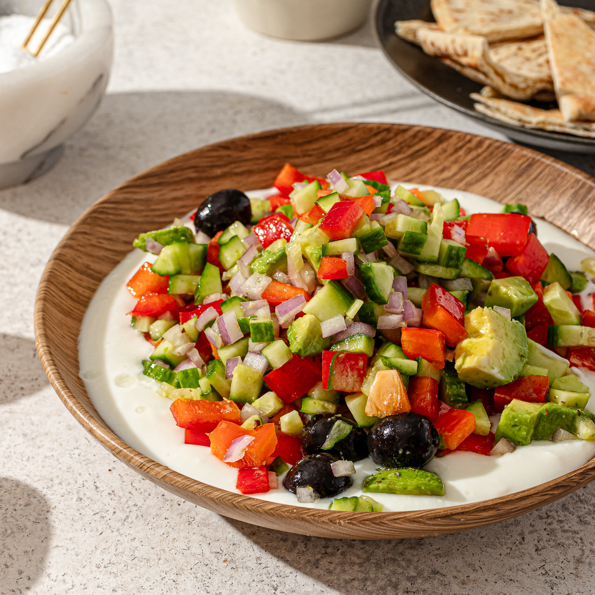 A serving of Labneh salad in a bowl with toppings.