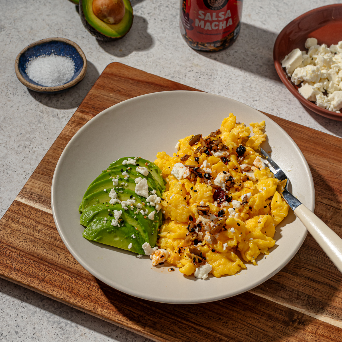 A serving of scrambled eggs without milk with sides and toppings.
