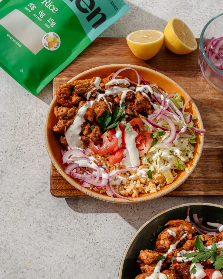 Halal Cart Chicken in a bowl with sauce and toppings.