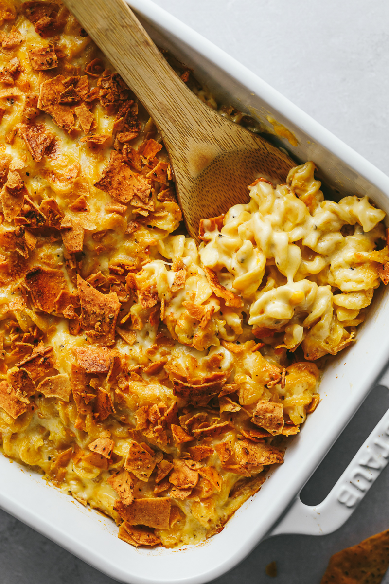 Close up of high protein mac and cheese recipe with wooden spoon.