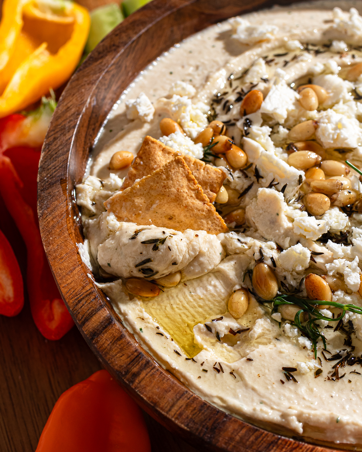 Crackers dipping in a roasted garlic dip recipe.