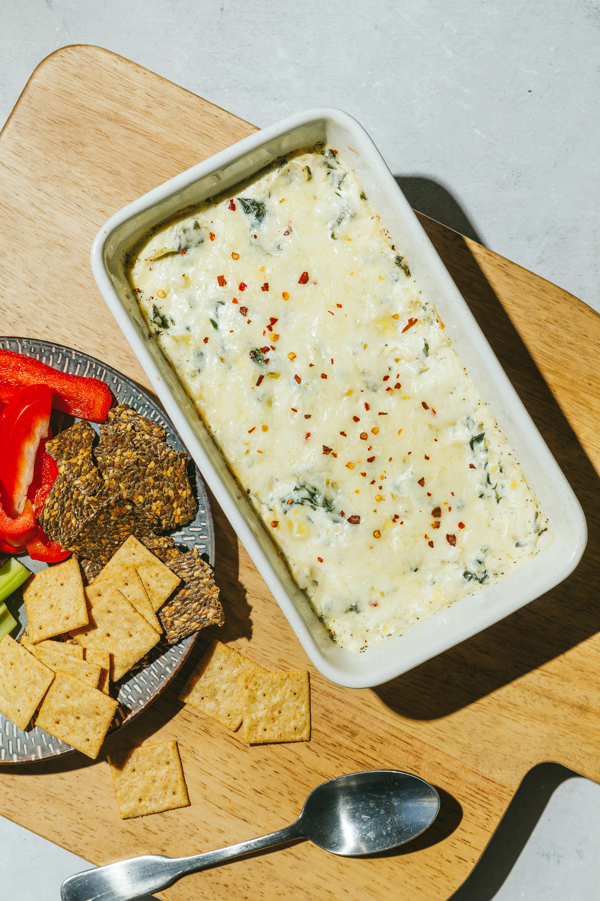 high protein spinach artichoke dip in a pan