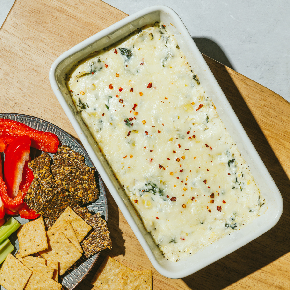 high protein spinach artichoke dip in a pan
