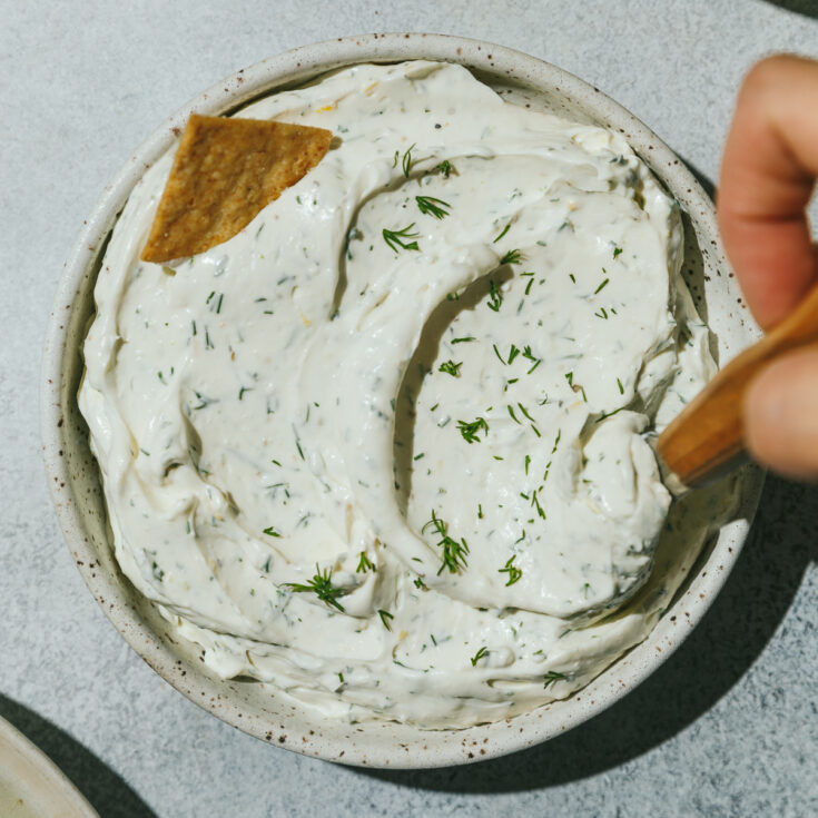 Low-carb dill cream cheese spread in a bowl with a cracker.