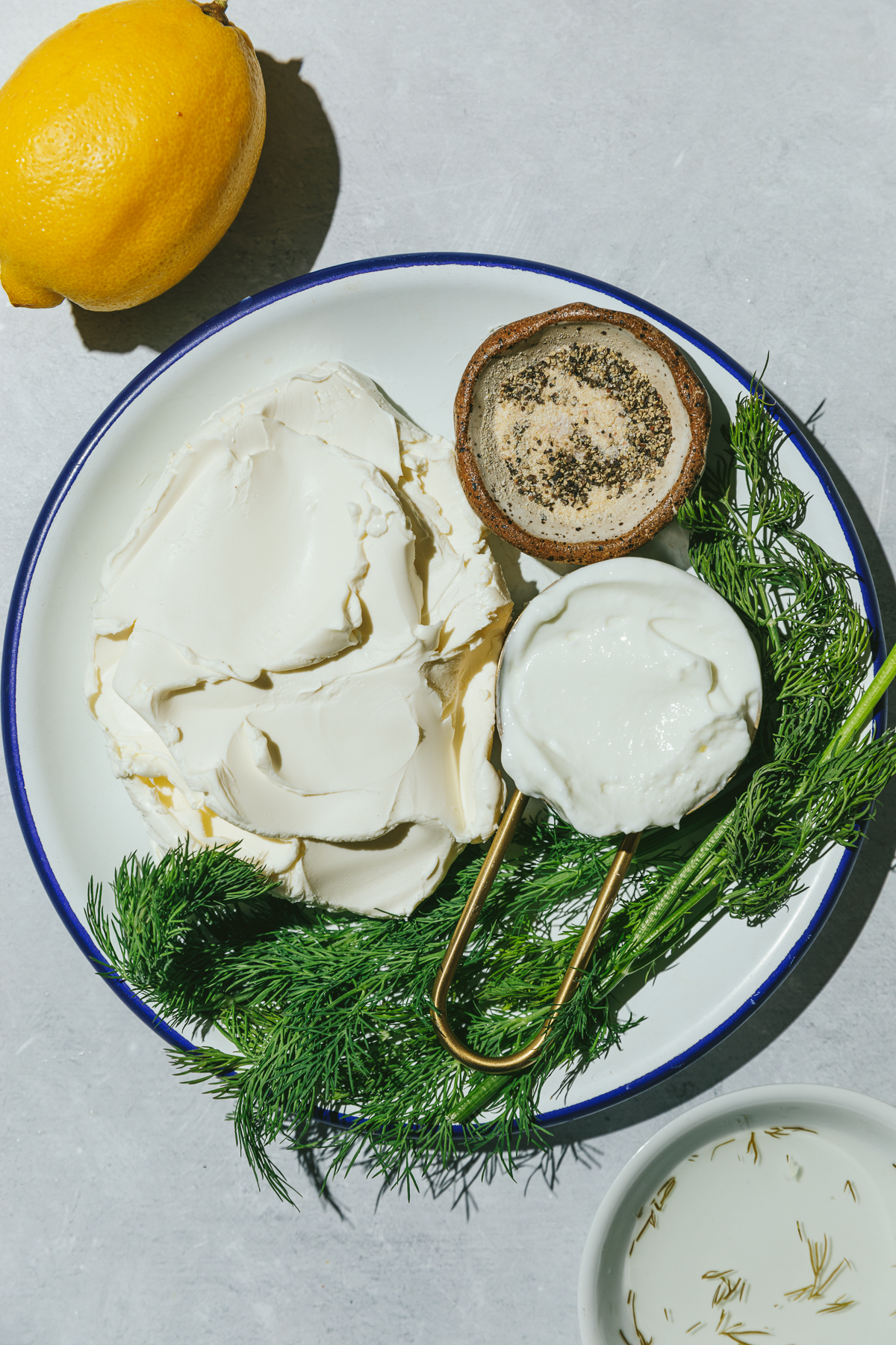 Ingredients for dill cream cheese spread on a plate.