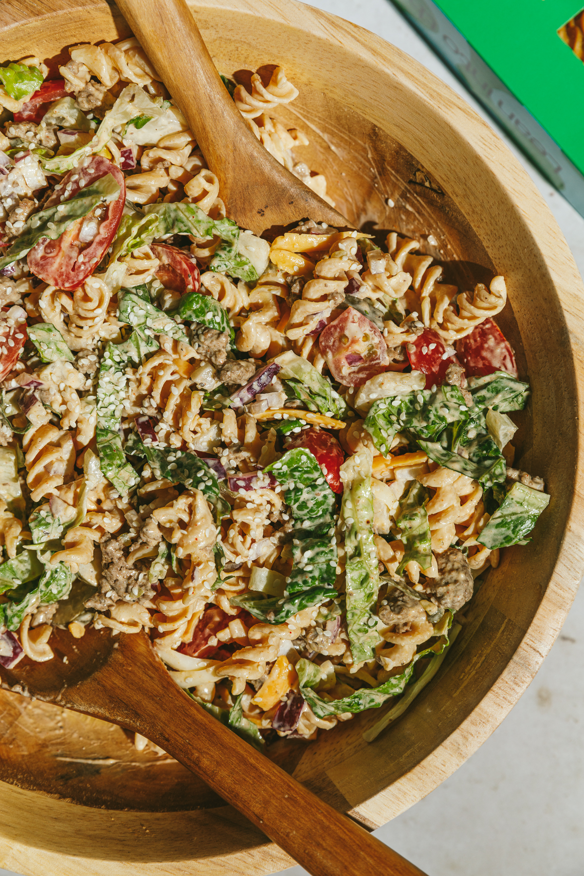 A wooden bowl with Big Mac pasta salad.