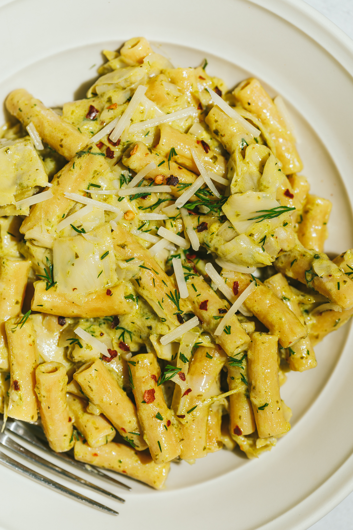 close up of artichoke pesto pasta