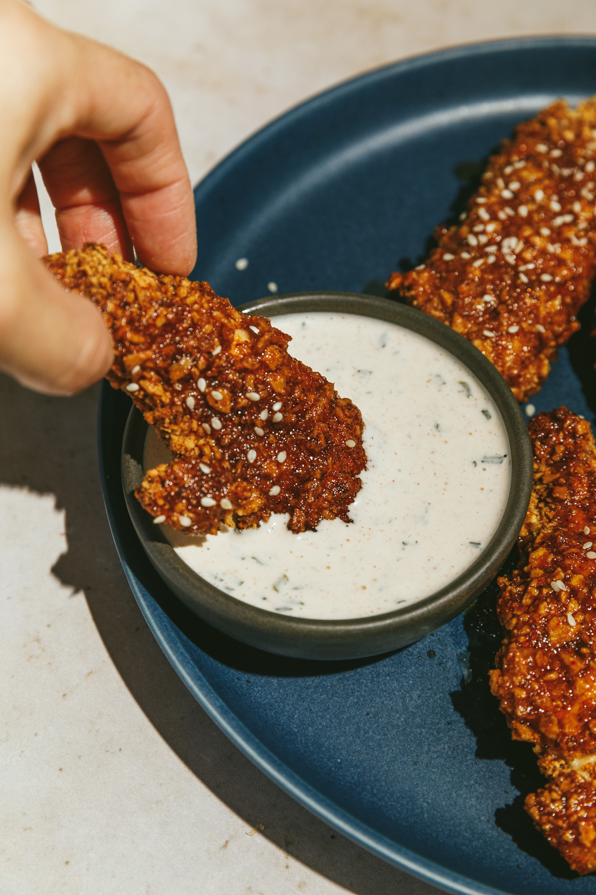 dipping low carb sticky chicken tenders in ranch
